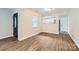 Inviting living room with wood-look flooring, a view to the kitchen, and ample natural light at 2424 Pitts Dr, Charlotte, NC 28216