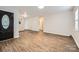 Open-concept living area with modern flooring, neutral walls, and a view into the kitchen at 2424 Pitts Dr, Charlotte, NC 28216