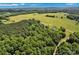 Expansive aerial view of property surrounded by lush green fields and dense forests at 2853 Mathis Church Rd, Catawba, NC 28609