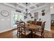 Elegant dining room with chandelier, hardwood floors, and views to covered porch and backyard at 2853 Mathis Church Rd, Catawba, NC 28609