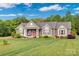 Charming single-story home featuring neutral siding, a welcoming front porch, and lush landscaping at 2853 Mathis Church Rd, Catawba, NC 28609