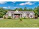Charming exterior of home with well-manicured lawn, covered porch, and meticulous landscaping at 2853 Mathis Church Rd, Catawba, NC 28609