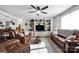 Spacious living room featuring built-in shelving, ceiling fan, and comfortable leather seating at 2853 Mathis Church Rd, Catawba, NC 28609
