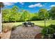 An outdoor kitchen area on a stone patio features a built-in grill and stunning backyard views at 2853 Mathis Church Rd, Catawba, NC 28609