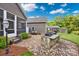 A stone outdoor kitchen area features a built-in grill and beautiful backyard and porch views at 2853 Mathis Church Rd, Catawba, NC 28609
