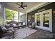 Inviting screened porch featuring comfortable seating, a ceiling fan, and serene outdoor views at 2853 Mathis Church Rd, Catawba, NC 28609