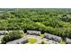Aerial view showcases townhomes nestled in a lush green neighborhood surrounded by dense trees and ample parking at 3021 Misty Harbor Cir, Cramerton, NC 28032