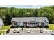 An aerial view of the townhomes with a parking lot in front and lush greenery in the background at 3021 Misty Harbor Cir, Cramerton, NC 28032