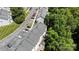 A birds-eye view displays the row of townhomes alongside a parking lot and lush foliage at 3021 Misty Harbor Cir, Cramerton, NC 28032