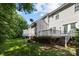 Spacious backyard featuring a raised deck and shed, bordered by mature trees at 3021 Misty Harbor Cir, Cramerton, NC 28032