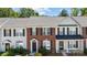 Charming brick townhouse with black shutters, front yard landscaping, and inviting entrance at 3021 Misty Harbor Cir, Cramerton, NC 28032