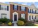 Charming red brick townhome with black shutters and well-maintained landscaping in a residential neighborhood at 3021 Misty Harbor Cir, Cramerton, NC 28032