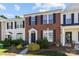 Charming brick townhome featuring dark shutters, trimmed bushes, and well-kept landscaping at 3021 Misty Harbor Cir, Cramerton, NC 28032