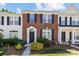 Traditional brick townhome with black shutters, well-maintained landscaping, and inviting entrance at 3021 Misty Harbor Cir, Cramerton, NC 28032