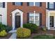 Inviting brick townhome with black door, trimmed bushes, and manicured lawn at 3021 Misty Harbor Cir, Cramerton, NC 28032