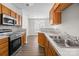 Functional kitchen featuring stainless steel appliances, wood cabinets, and a convenient layout at 3021 Misty Harbor Cir, Cramerton, NC 28032