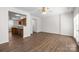 Spacious living room with wood-look floors, neutral walls, and abundant natural light, connected to kitchen at 3021 Misty Harbor Cir, Cramerton, NC 28032