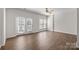 Bright living room with wood floors, a ceiling fan and many windows for ample natural light at 3021 Misty Harbor Cir, Cramerton, NC 28032