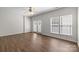 Bright living room with wood floors, a ceiling fan and many windows for ample natural light at 3021 Misty Harbor Cir, Cramerton, NC 28032