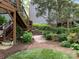 Backyard featuring lush landscaping, a wooden deck, and a play structure at 3133 English Sparrow Ln, Charlotte, NC 28210