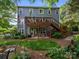 Expansive backyard featuring an inviting deck, lush garden, and charming outdoor seating area at 3133 English Sparrow Ln, Charlotte, NC 28210