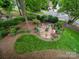 Charming backyard retreat featuring a cozy fire pit, lounge seating, lush landscaping and privacy at 3133 English Sparrow Ln, Charlotte, NC 28210