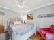 Charming bedroom with hardwood floors, a ceiling fan, and a light blue wall with cottage decor accents at 3133 English Sparrow Ln, Charlotte, NC 28210