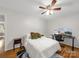 Bright bedroom features hardwood floors, a ceiling fan and a picture window, along with a desk for work at 3133 English Sparrow Ln, Charlotte, NC 28210