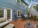 Exterior view of deck with furniture, bar seating, and views of a lush, green yard at 3133 English Sparrow Ln, Charlotte, NC 28210