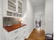 Hallway with a built-in serving area and access to the living and dining areas at 3133 English Sparrow Ln, Charlotte, NC 28210
