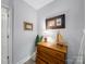 Charming hallway showcasing a wooden dresser with a nautical theme, plus neutral paint and updated flooring at 3133 English Sparrow Ln, Charlotte, NC 28210