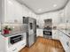Bright kitchen features white cabinets, stainless steel appliances, and granite countertops at 3133 English Sparrow Ln, Charlotte, NC 28210