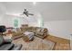 Expansive living room with hardwood floors, two large windows and a sectional sofa for a relaxed atmosphere at 3133 English Sparrow Ln, Charlotte, NC 28210