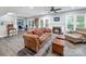 Cozy living room with a fireplace, doors to patio, and plenty of natural light creating an inviting space at 3133 English Sparrow Ln, Charlotte, NC 28210