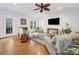 Spacious living room with fireplace, ceiling fan, and abundant natural light at 3133 English Sparrow Ln, Charlotte, NC 28210