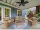 Covered porch with wicker furniture, ceiling fan, and view of the home's exterior and backyard access at 3133 English Sparrow Ln, Charlotte, NC 28210