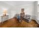 Cozy sitting room with hardwood floors, comfortable armchairs, and a decorative wine rack at 3133 English Sparrow Ln, Charlotte, NC 28210