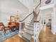 Elegant staircase with white railings, carpeted steps, and views of the dining room at 3133 English Sparrow Ln, Charlotte, NC 28210