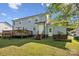 Expansive backyard featuring a wooden deck and well-maintained lawn, perfect for outdoor entertaining and relaxation at 3223 Rheinwood Ct, Matthews, NC 28105