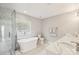 Modern bathroom featuring a soaking tub, separate shower, and dual sinks at 3223 Rheinwood Ct, Matthews, NC 28105