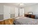 Spacious bedroom with hardwood floors and a computer desk at 3223 Rheinwood Ct, Matthews, NC 28105