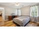 Comfortable bedroom with hardwood floors, computer desk, and natural light at 3223 Rheinwood Ct, Matthews, NC 28105