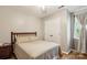 Neutral bedroom with wood floors, a double bed, a large closet, and a window at 3223 Rheinwood Ct, Matthews, NC 28105