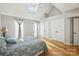 Bright bedroom featuring hardwood floors, a vaulted ceiling, and ample closet space at 3223 Rheinwood Ct, Matthews, NC 28105