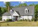 Charming single Gathering home featuring a manicured front lawn, brick chimney, and inviting front porch at 3223 Rheinwood Ct, Matthews, NC 28105