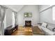 Inviting living room showcasing a fireplace, hardwood floors, and modern decor at 3223 Rheinwood Ct, Matthews, NC 28105