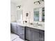 Bathroom featuring double sink vanity, marble countertop, gray cabinets, decorative lighting, and framed mirror at 397 Luray Way, Rock Hill, SC 29730