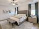 Bright bedroom featuring neutral color palette, tray ceiling, ceiling fan, and gray upholstered bed frame at 397 Luray Way, Rock Hill, SC 29730