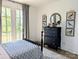 Airy bedroom features a black dresser, stylish decor, and access to a balcony at 397 Luray Way, Rock Hill, SC 29730