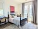 Bright bedroom with a black four-poster bed, chic decor, and access to a balcony at 397 Luray Way, Rock Hill, SC 29730